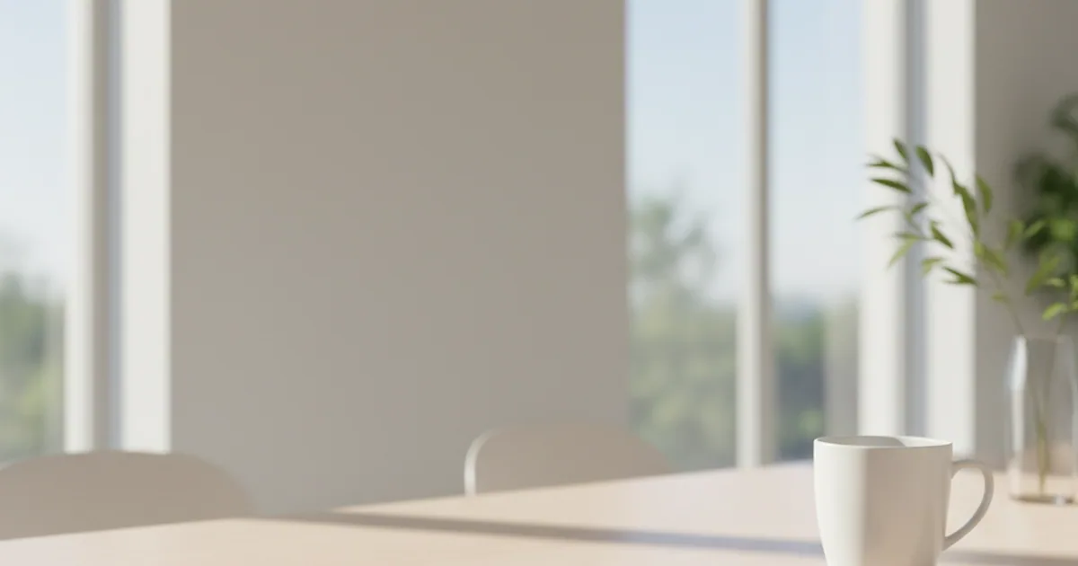A phone on a table beside a coffee cup in soft morning light, no visible interface